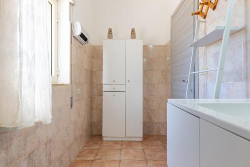 a bathroom with a white cabinet and a sink at Il Canto della Cicala in San Vito dei Normanni