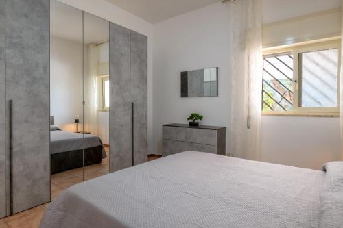 a bedroom with a bed and a mirror at Il Canto della Cicala in San Vito dei Normanni