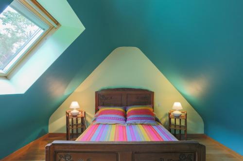 a bedroom with a bed in a roof at Gîte Ty Nevez in Lanvellec