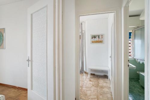 a hallway with a mirror and a bathroom at Margherita in Ospedaletti
