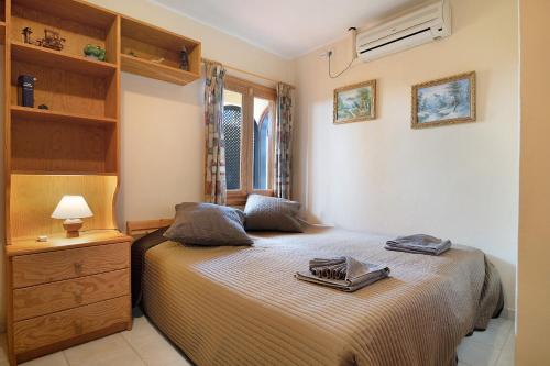 a bedroom with a bed with a dresser and a window at Villa Mar in Teguise