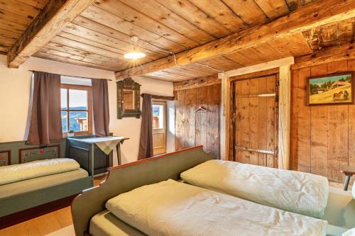 a living room with a couch and wooden walls at Historisches Apartment Duregghof in San Genesio Atesino