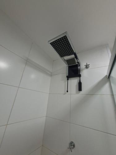 a shower with a vent on the ceiling at Flat 203 Red Sorocaba in Sorocaba