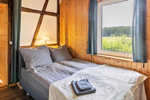 a bed in a room with a window at Elbtalquartier im Grünen in Bleckede