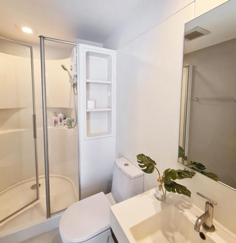 a bathroom with a toilet and a sink and a shower at Diamond in Bangkok
