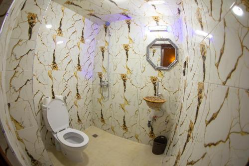 a dirty bathroom with a toilet and a mirror at Dar Chbili Fès in Fez