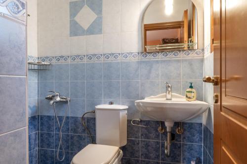 a bathroom with a toilet and a sink at Moraki Apartment 2 Andros in Korthi