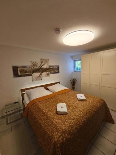a bedroom with a bed with two towels on it at Bei s' Herrs in Rheinmunster