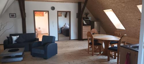 a living room with a blue couch and a table at Haus beim Schloß in Woldegk