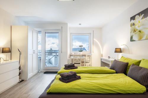 a bedroom with two beds with yellow sheets at Schwarzwaldblick D App 8 mit Pool in Schönwald