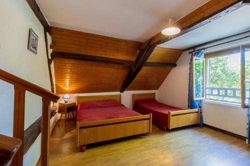a bedroom with two beds and a window at Gite à la campagne in Ginestet