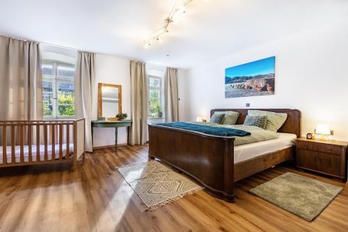 a bedroom with a large bed and a staircase at Kempers Auszeit in Plettenberg