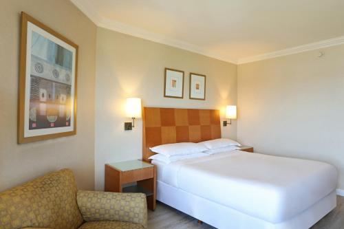 a hotel room with a bed and a chair at Sheraton Buenos Aires Hotel & Convention Center in Buenos Aires