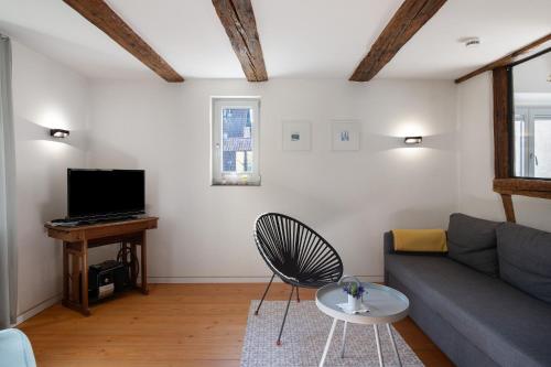 a living room with a couch and a table at Ferienhaus Hildahüsli in Badenweiler