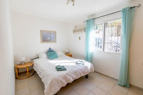 a bedroom with a bed and a window at Casa La Paz in Torrox