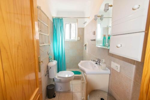 a small bathroom with a toilet and a sink at Casa La Paz in Torrox