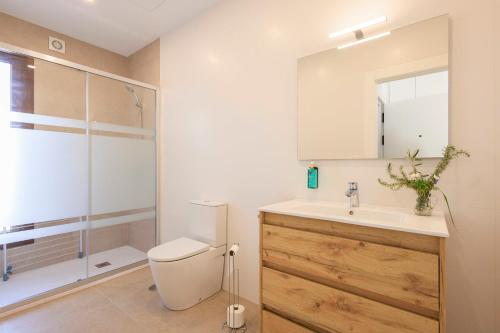 a bathroom with a toilet and a sink and a shower at Apartamentos Turísticos Olivares in Mota del Cuervo