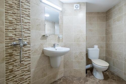 a bathroom with a toilet and a sink and a shower at Julia rooms in Sofia