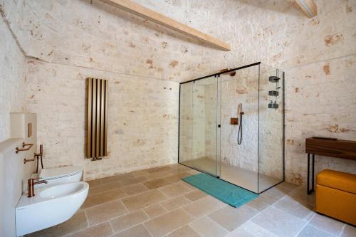 a bathroom with a shower and a toilet and a sink at Dimora Dormio in Monopoli