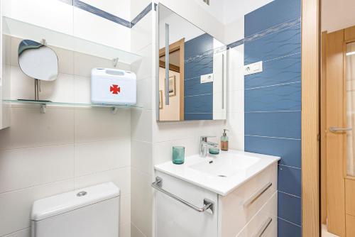 a bathroom with a white toilet and a sink at Apartamento Sol Playa Torrox A55 in Torrox Costa