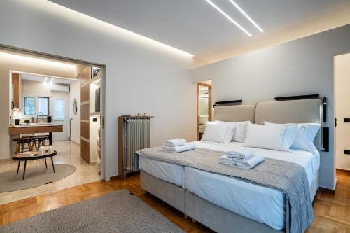 a bedroom with a large bed and a living room at The Apex Boutique Apartment B2 in Athens