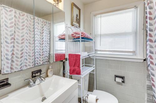 a bathroom with a sink and a toilet and a mirror at Walk to Shops & Eats! Attleboro Basecamp in Attleboro