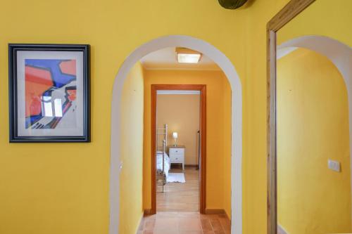 a hallway with yellow walls and a picture on the wall at Villa Casa Concha in Teguise