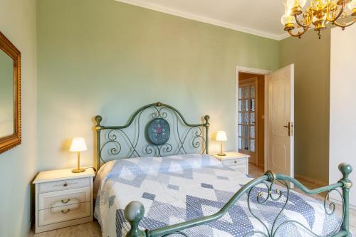 a bedroom with a bed and two night stands and two lamps at Villa La Lanterna Bianca a Bagnone in Bagnone
