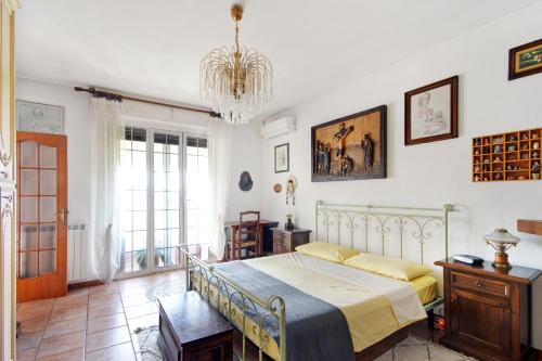 a bedroom with a bed and a chandelier at Ca Olivella in Casarza Ligure