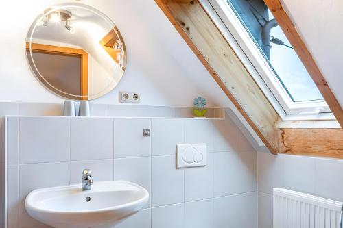 a bathroom with a sink and a mirror at Fewo Edith in Gersfeld
