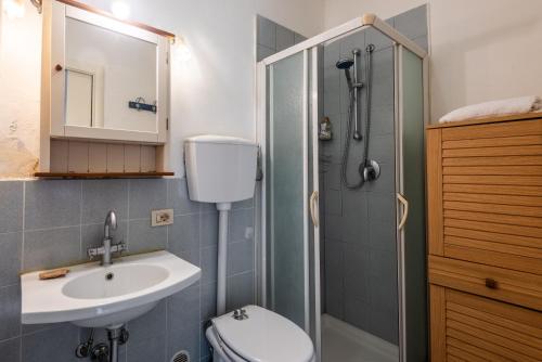 a bathroom with a toilet and a sink and a shower at Nido blu loft in Siena