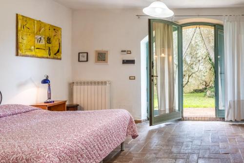 a bedroom with a bed and a sliding glass door at Nido blu loft in Siena