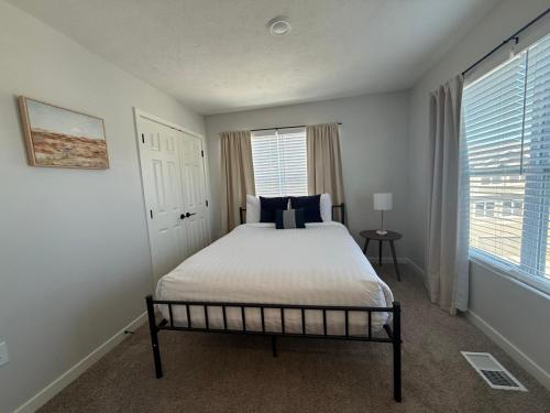 a bedroom with a bed and a window at The HoneyBee at Coventry Rows in Omaha