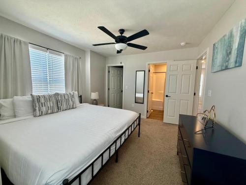 a bedroom with a bed and a ceiling fan at The HoneyBee at Coventry Rows in Omaha