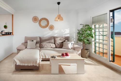 a living room with a couch and a table at Baviera Homes Sunset and Golf in Caleta De Velez