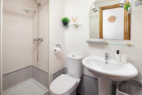 a bathroom with a toilet and a sink and a shower at Baviera Homes Sunset and Golf in Caleta De Velez