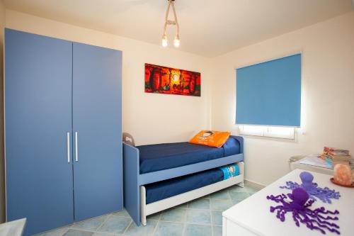 a childs room with a blue bunk bed at Casa Francesco in Orosei
