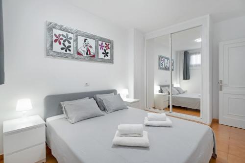 a bedroom with a white bed with two towels on it at Ocean Park 311 in Adeje