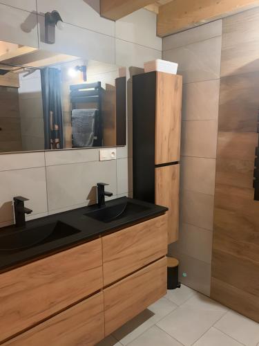 a bathroom with a sink and a mirror at Chalet Saint-Roch in Val Cenis