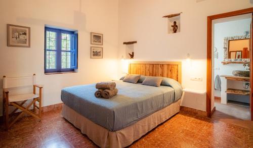 a bedroom with a bed with a teddy bear on it at Casa can Pep Martí in Sant Francesc Xavier