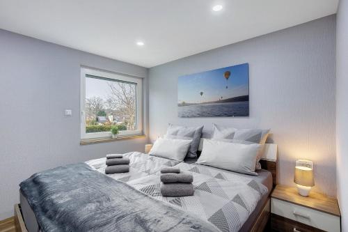 a bedroom with a large bed with towels on it at Ferienhaus Adelon in Möhnesee