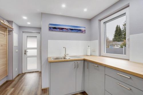 a kitchen with a sink and a window at Ferienhaus Adelon in Möhnesee