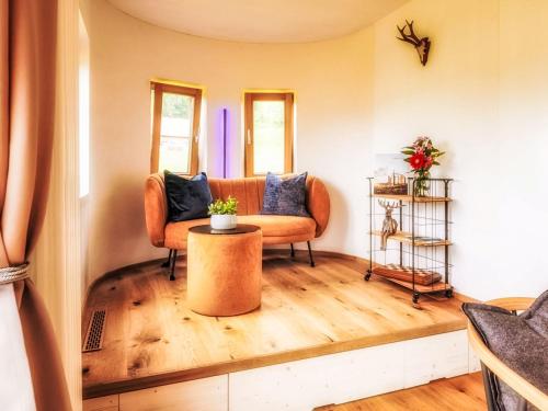 a living room with a couch and a table at Chalet Boutique Tiny House by Interhome in Rothenthurm