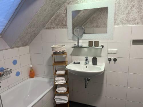 a bathroom with a sink and a bath tub at Plätzchen am Krebsberg in Simmerath