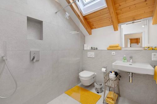 a bathroom with a shower and a toilet and a sink at Appartement Monte Fiori in Anzing