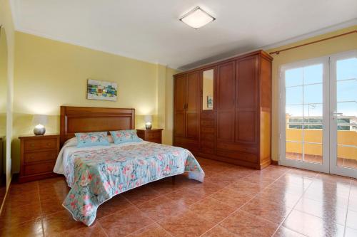 a bedroom with a bed and a large window at Casa Paco 3 in Costa Calma