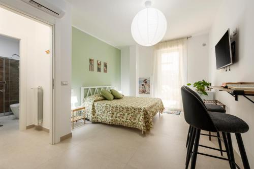 ein Schlafzimmer mit einem Bett, einem Tisch und einem Stuhl in der Unterkunft Lovi Room in Capaci