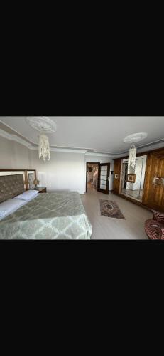a large bedroom with a bed and chandeliers at Trabzon 4 storey Villa-House by the sea - Denize sıfır 4 katlı müstakil Villa - Ev in Trabzon