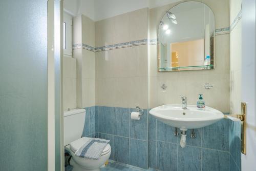 a bathroom with a sink and a toilet and a mirror at Villa sea view 2 in Athani
