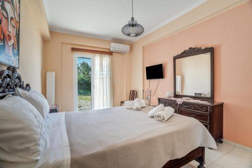 a bedroom with a bed with a mirror and a dresser at Villa sea view 2 in Athani